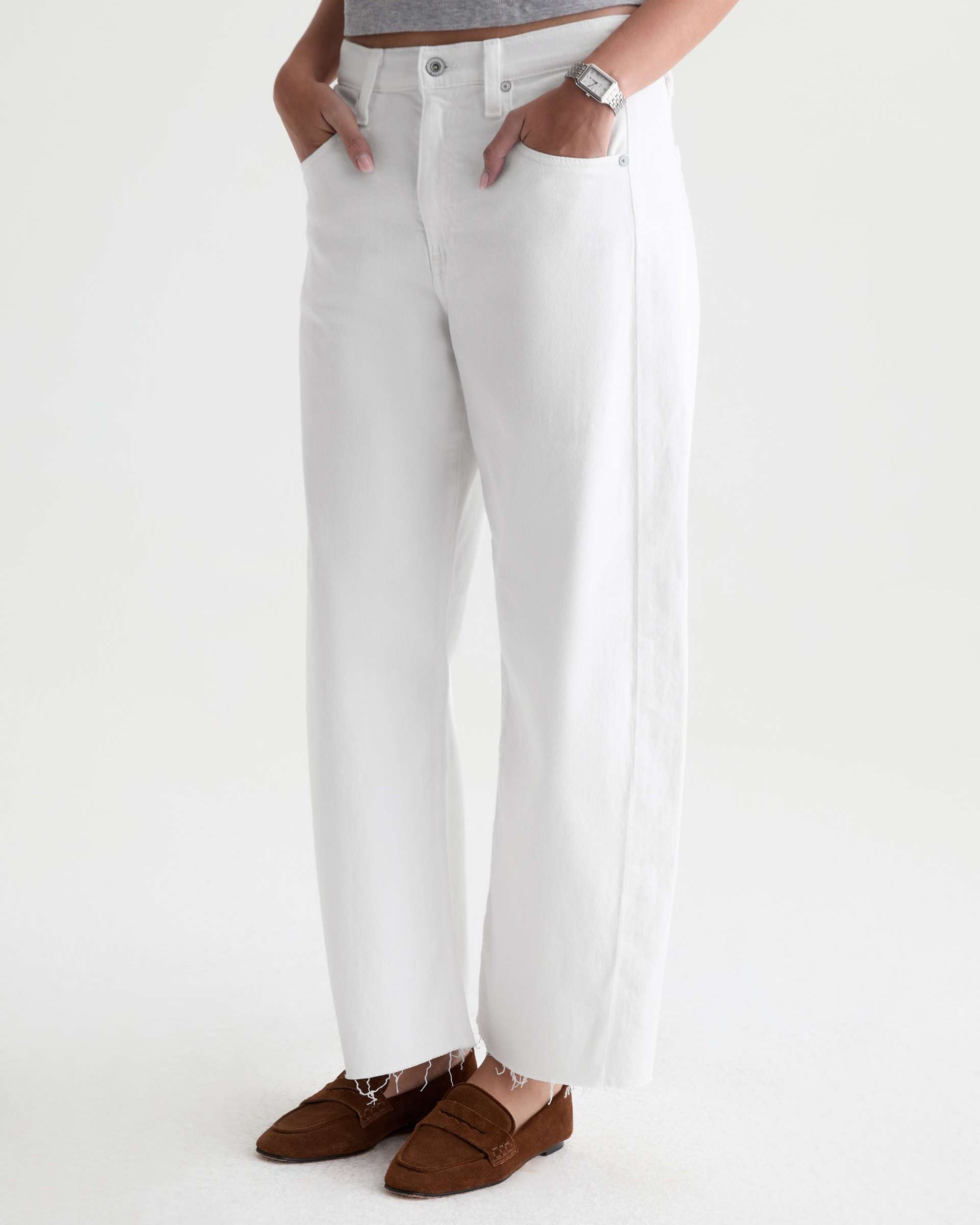 Person wearing white pants with a plain background