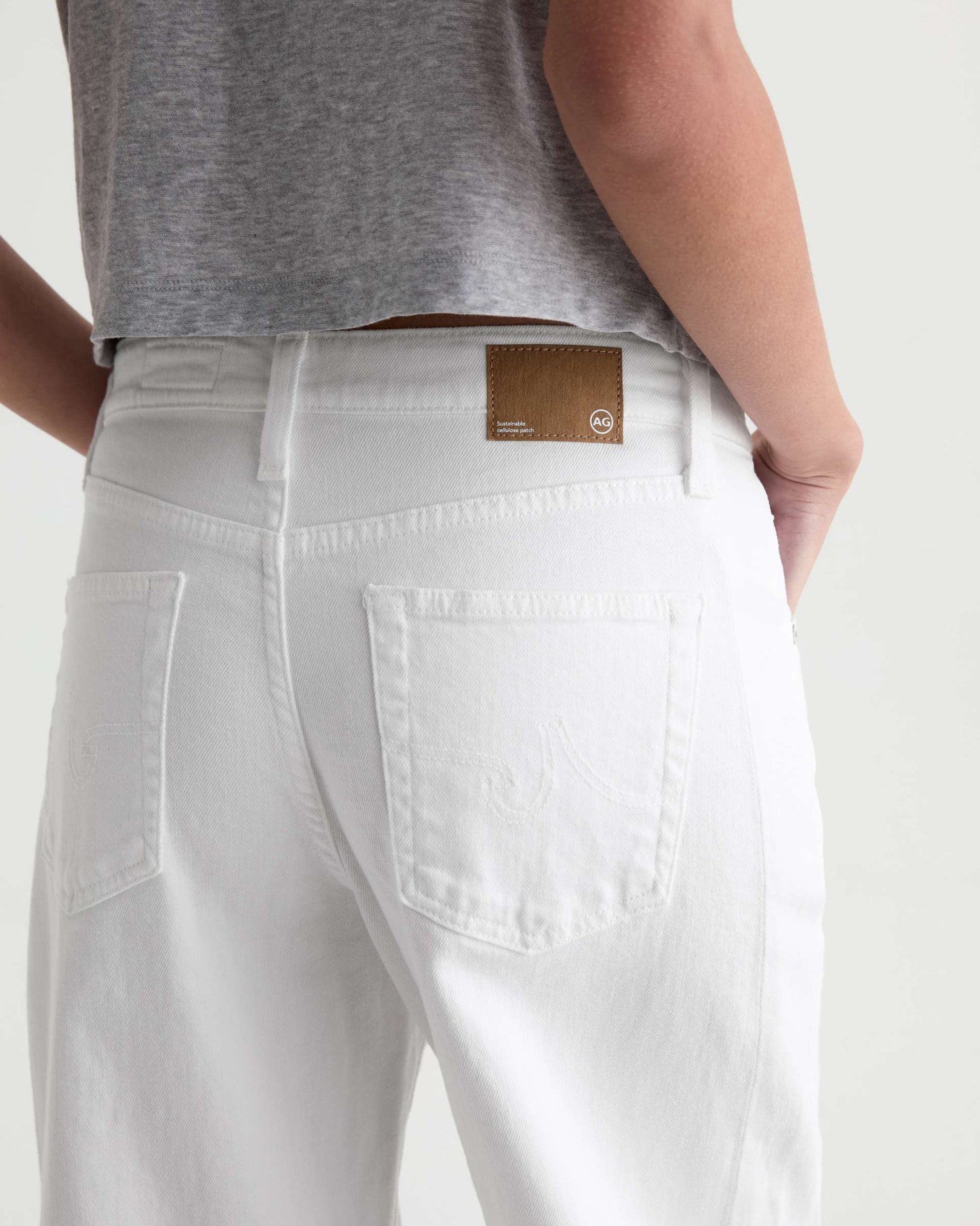 White pants with a brand label on a plain background
