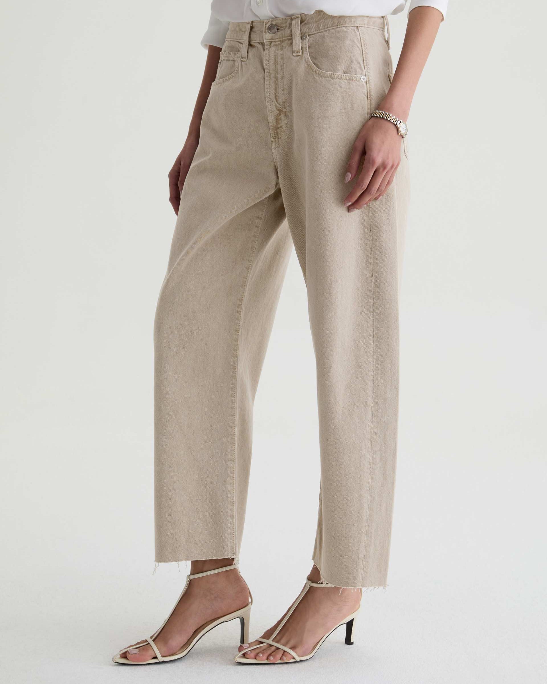 Beige pants worn by a person on a white background