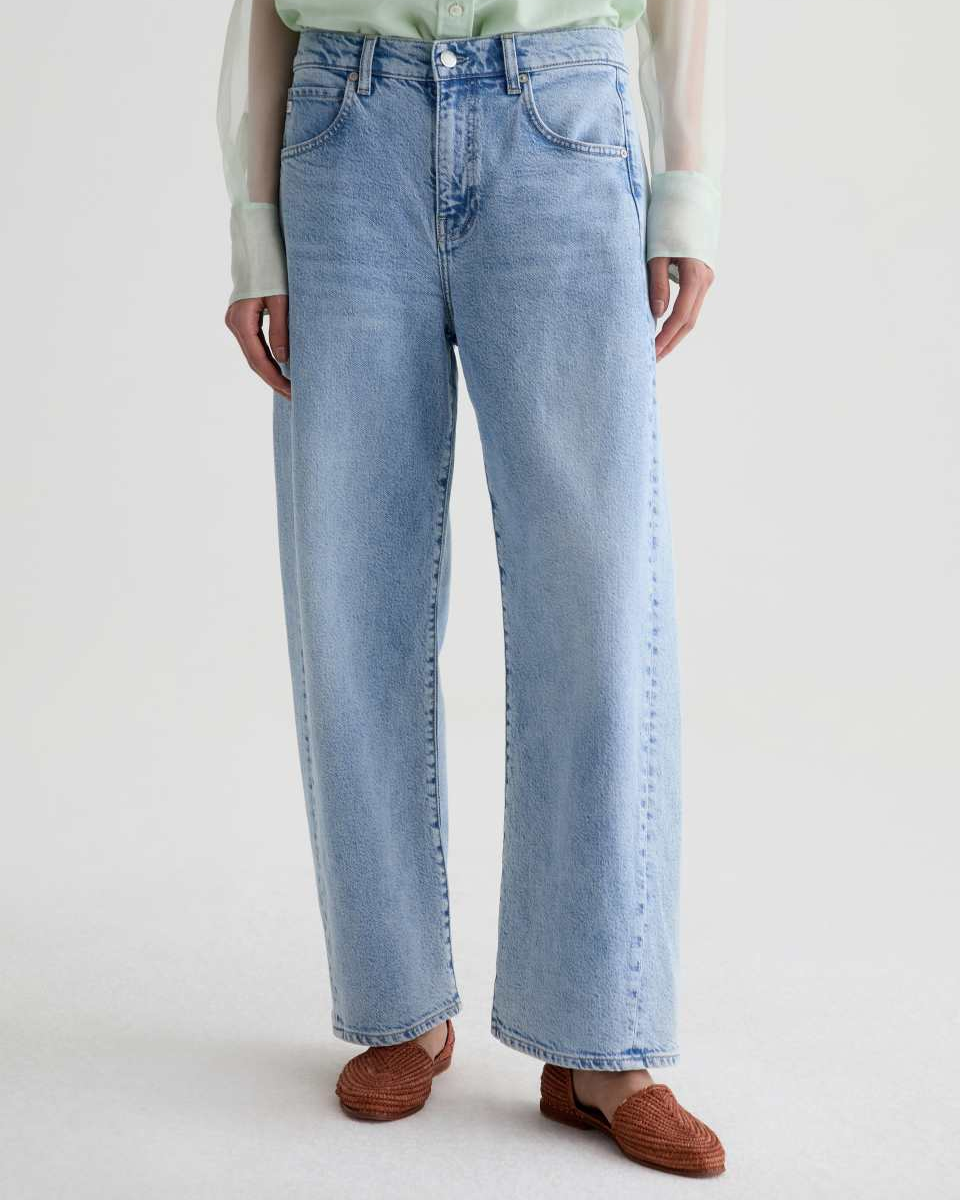 Light blue jeans worn by a person on a white background