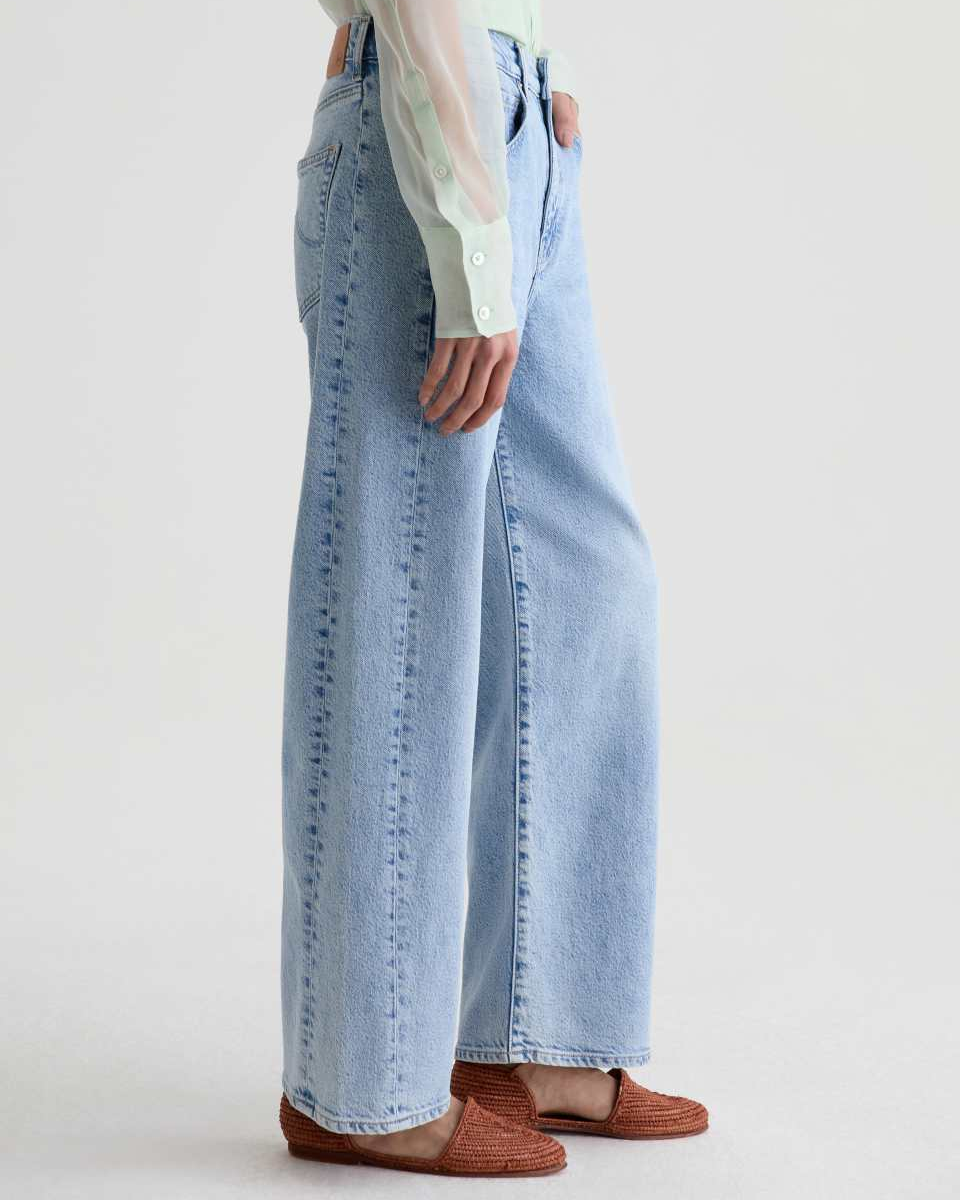 Light blue jeans worn by a person on a white background