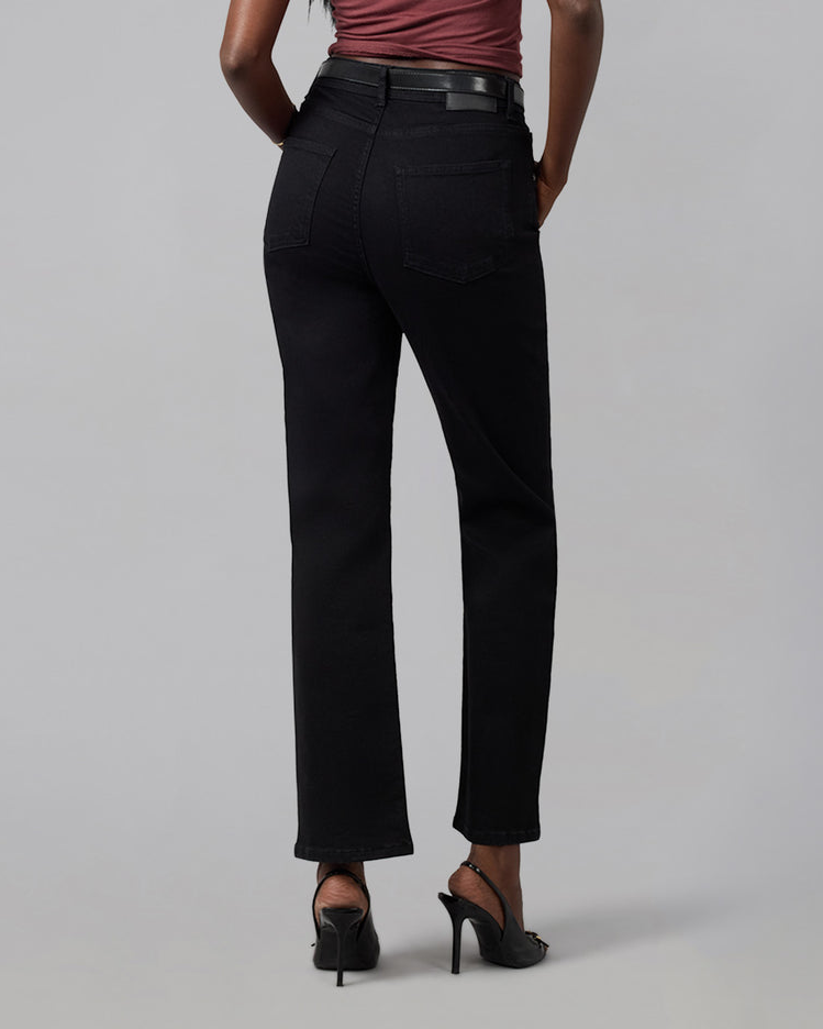 Person wearing black pants on a gray background