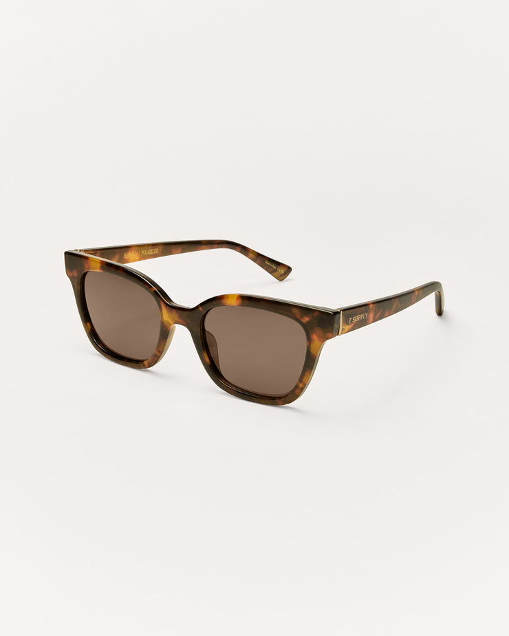 Sunglasses with tortoiseshell frame and dark lenses on a white background