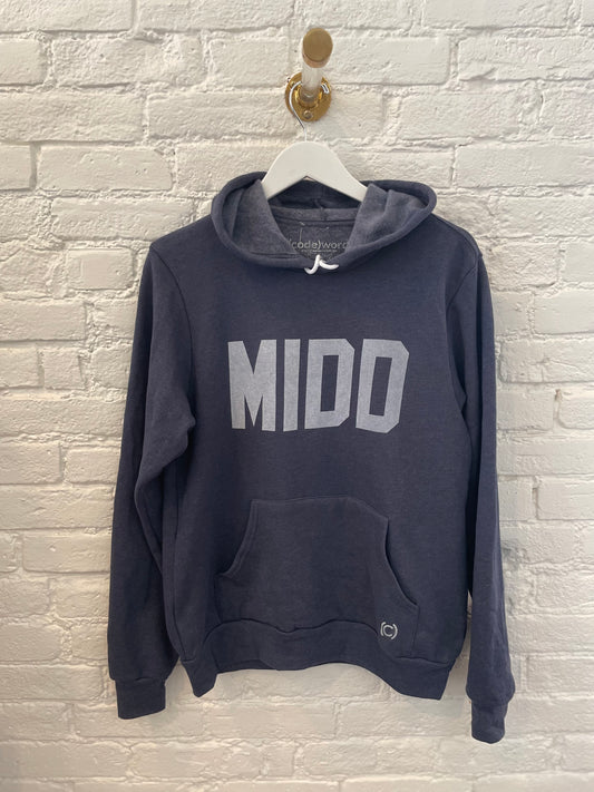 Image of Middlebury College MIDD sweatshirt handing up on a white brick wall
