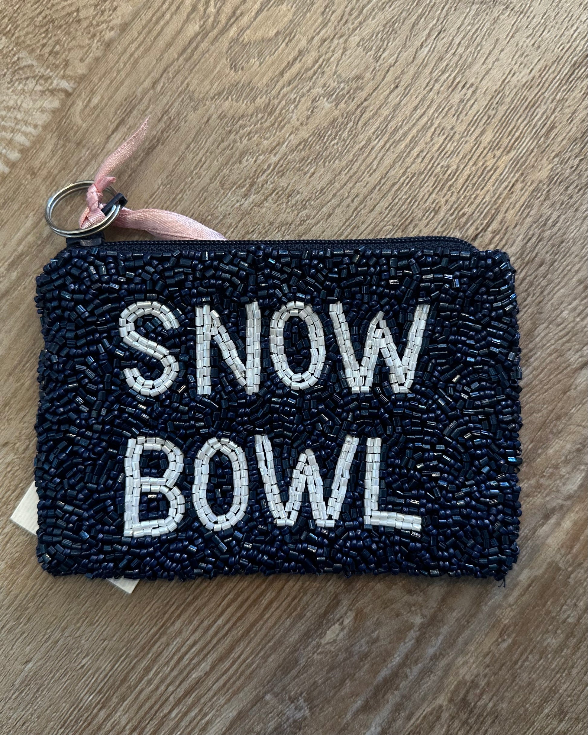 Image of snow bowl coin purse in navy and white on a wood background