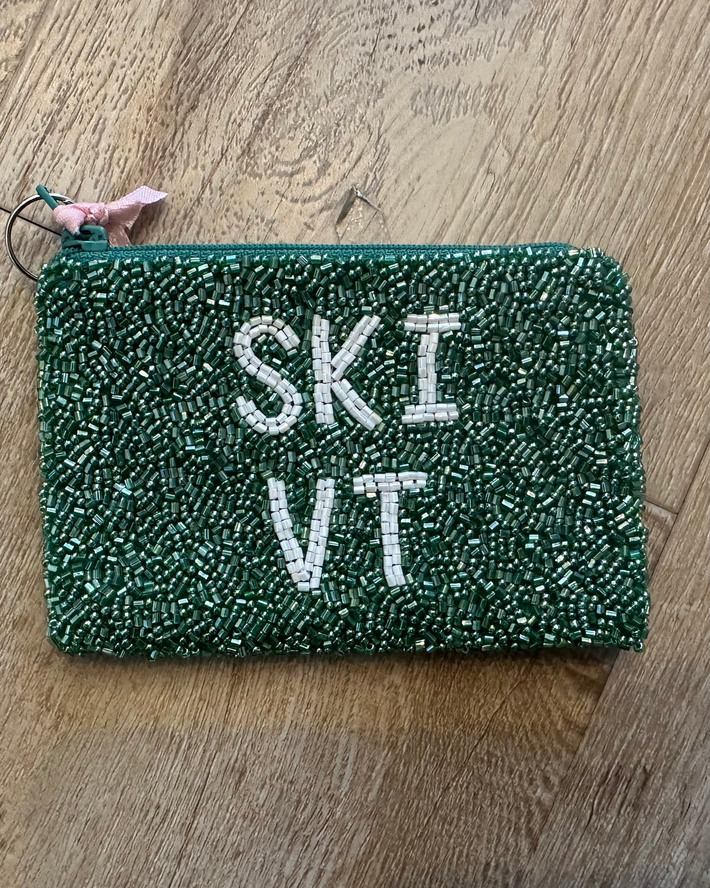 Image of ski Vermont in green and white on a wood background