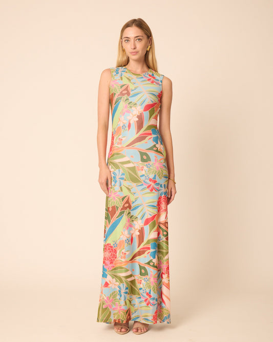 Woman wearing a colorful floral dress on a beige background