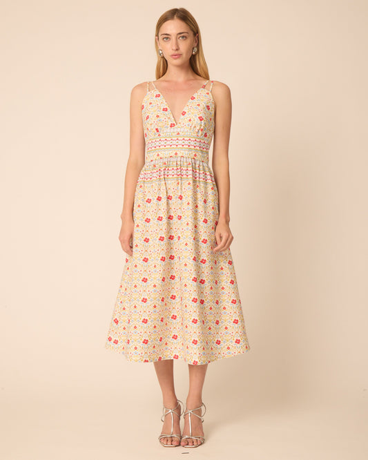 Woman wearing a floral dress against a beige background