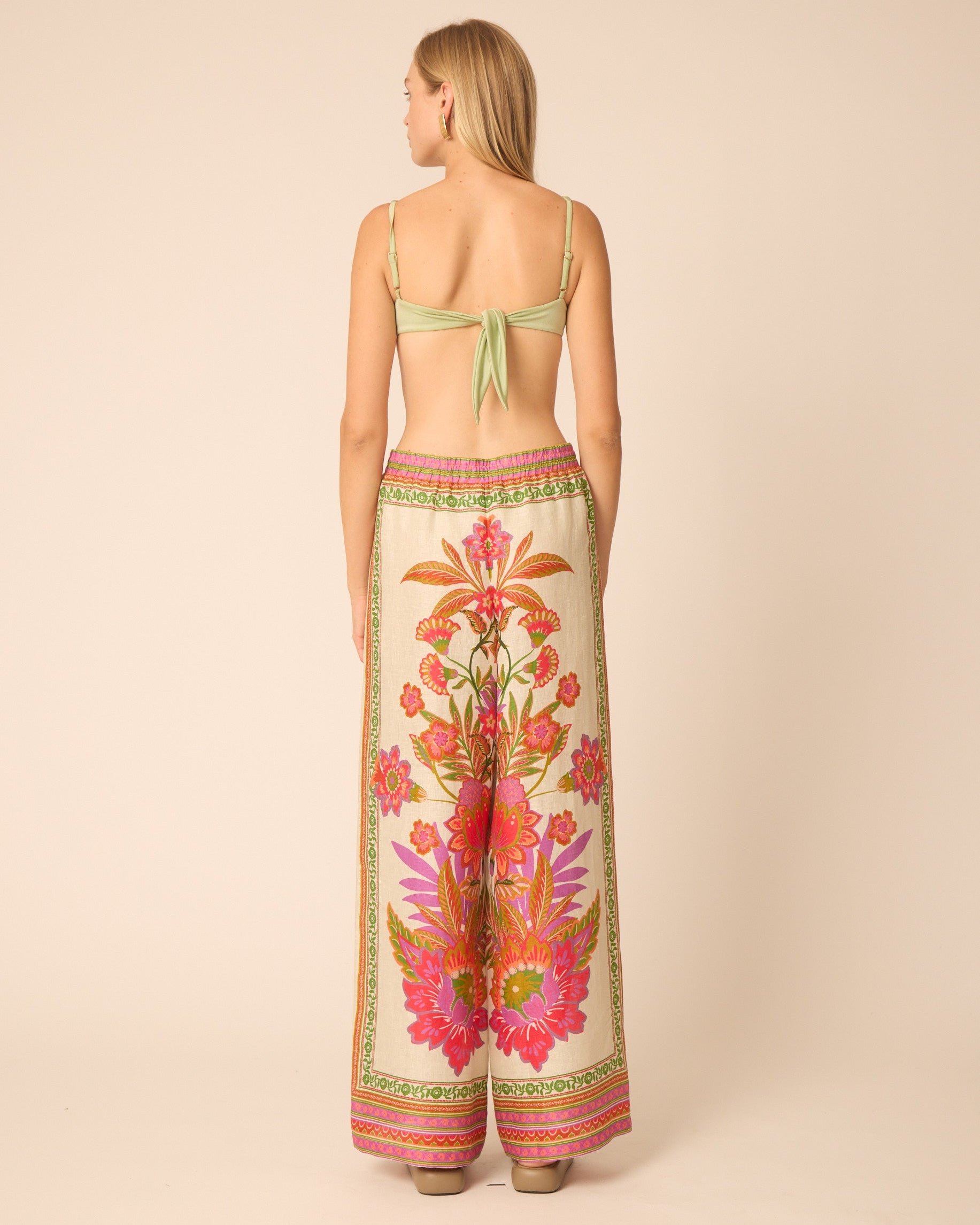 Woman wearing a floral dress with a beige background