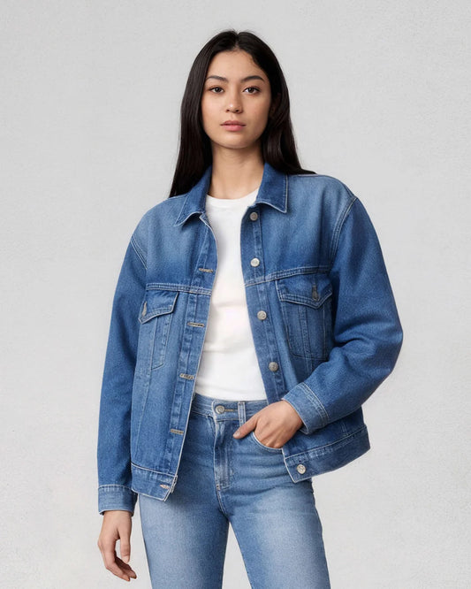 Person wearing a blue denim jacket and jeans on a plain background