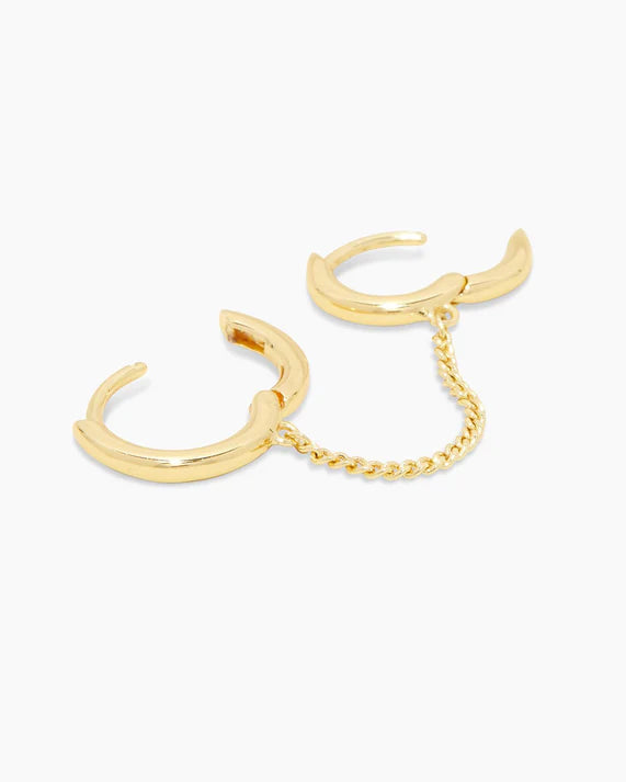 Gold hoop earrings with a chain on a white background
