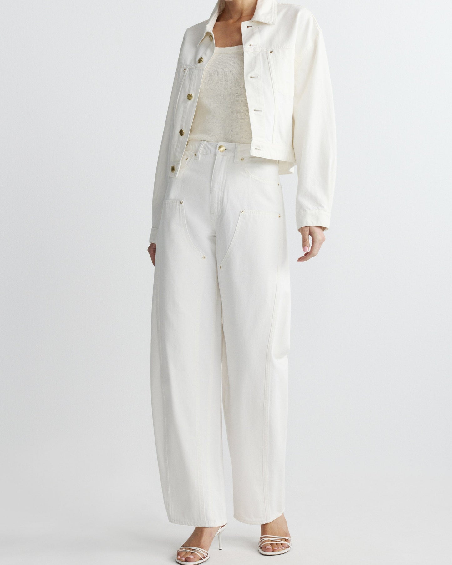Person wearing a white outfit with a jacket and pants on a white background
