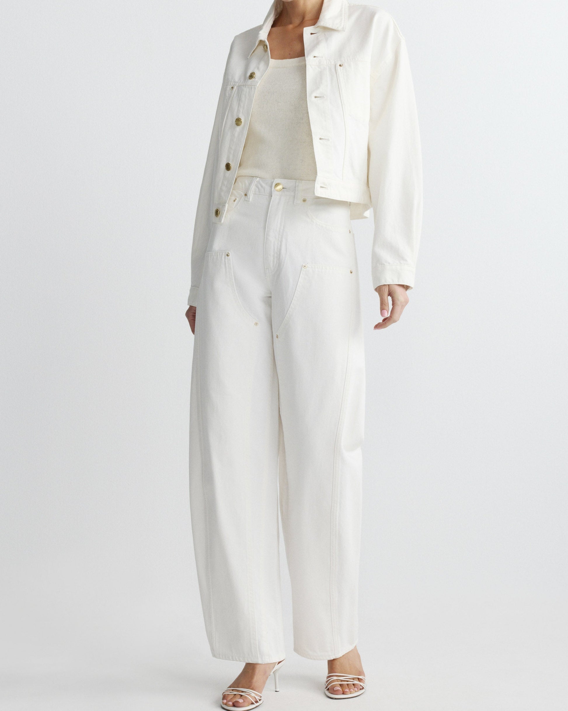 Person wearing a white outfit with a jacket and pants on a white background