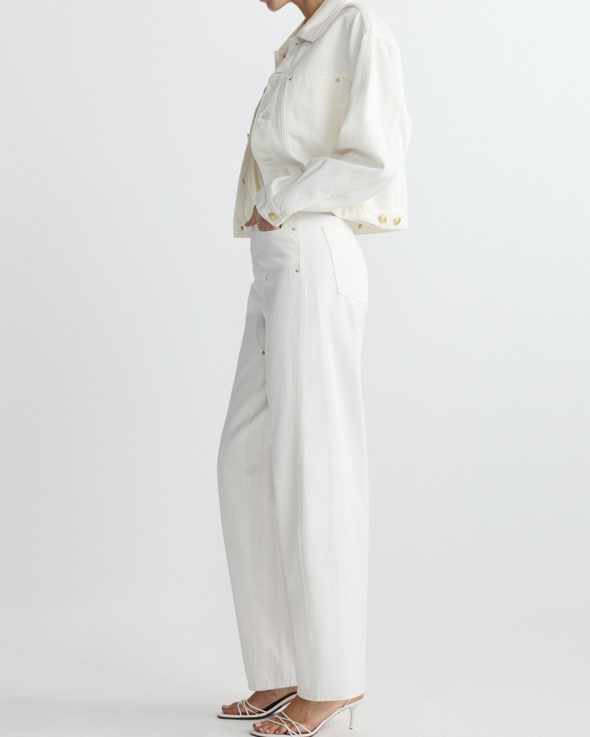 Person wearing a white outfit with a plain background