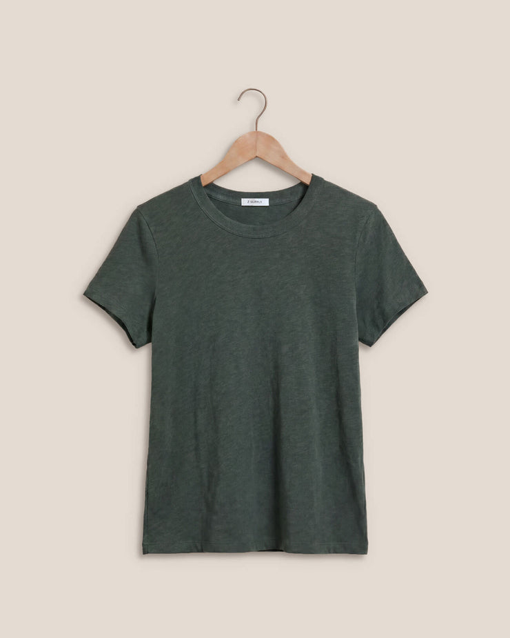 A dark green short-sleeve crewneck t-shirt hanging on a wooden hanger against a solid beige background.