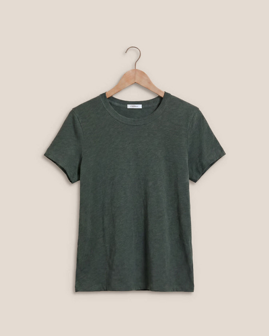 A dark green short-sleeve crewneck t-shirt hanging on a wooden hanger against a solid beige background.