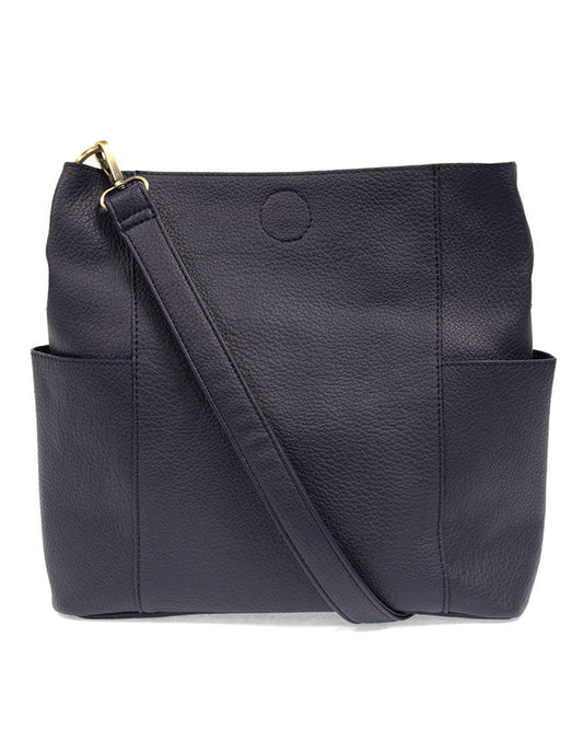 Navy vegan leather handbag with a shoulder strap on a white background