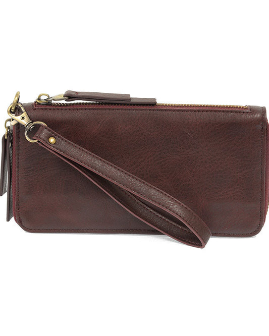 Wine vegan leather wallet with wrist strap against a white background.