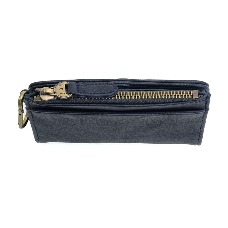 Navy vegan leather wallet with brass accents against a white background.