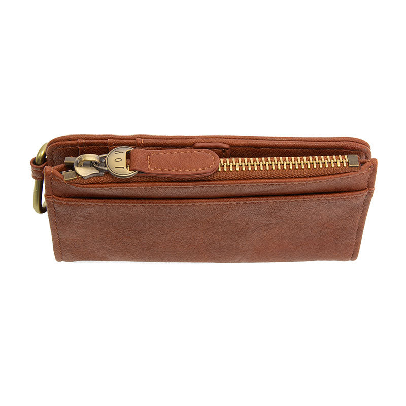Saddle vegan leather wallet with brass accents against a white background.
