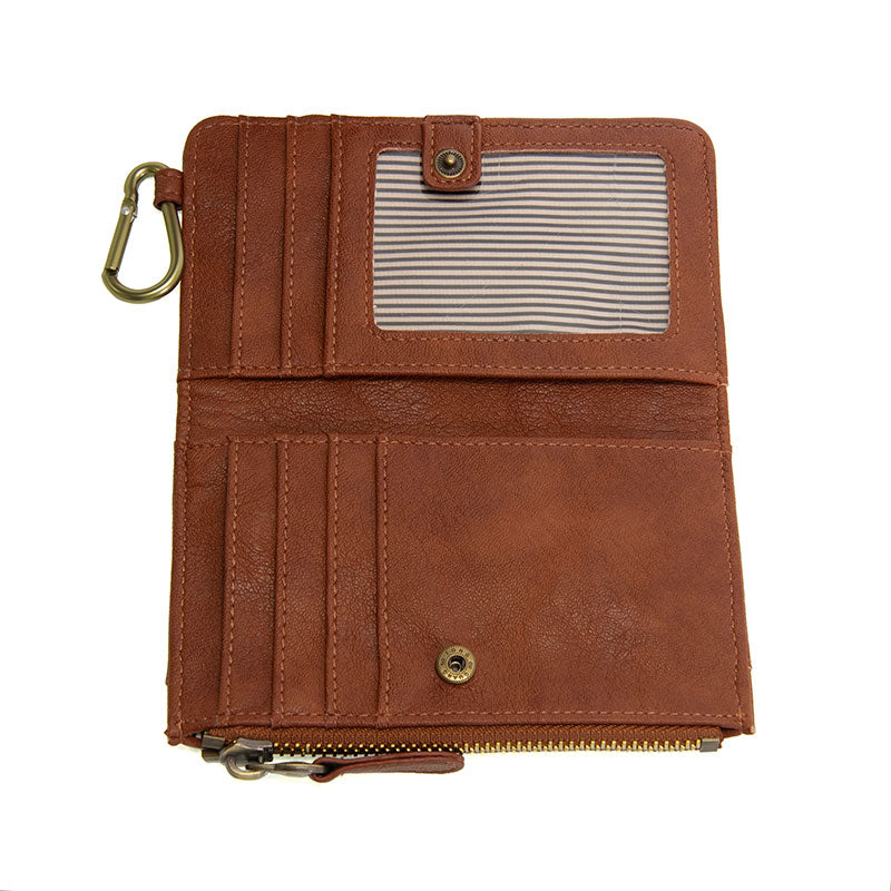 Saddle vegan leather wallet with brass accents opened against a white background.