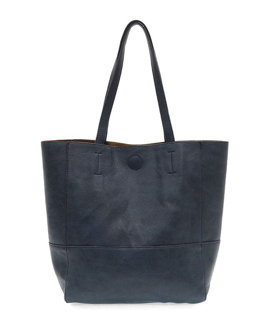 Navy vegan leather raw edge tote against a white background.