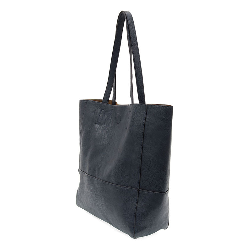 Black vegan leather raw edge tote against a white background.