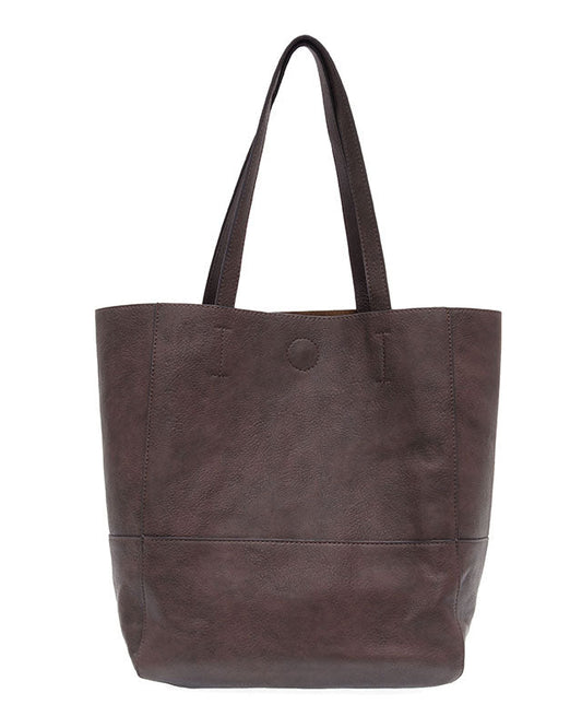 Espresso vegan leather raw edge tote against a white background.
