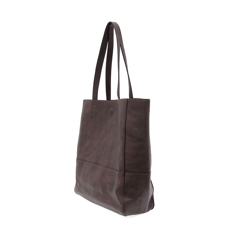 Espresso vegan leather raw edge tote against a white background.