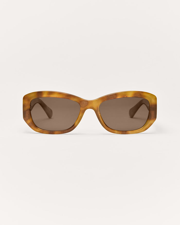 Sunglasses with tortoiseshell frame and dark lenses on a white background