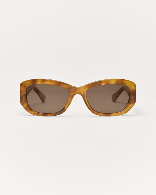 Sunglasses with tortoiseshell frame and dark lenses on a white background