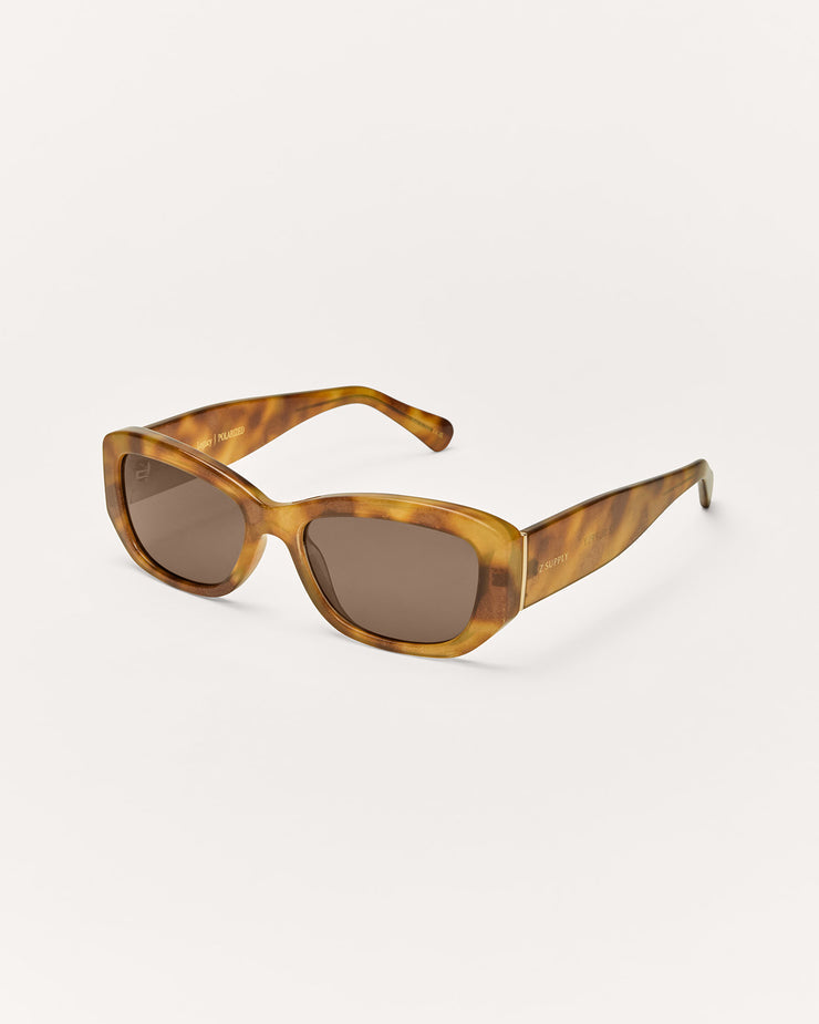 Sunglasses with tortoiseshell frame and brown lenses on a white background