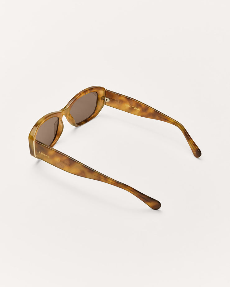 Sunglasses with tortoiseshell frame and brown lenses on a white background
