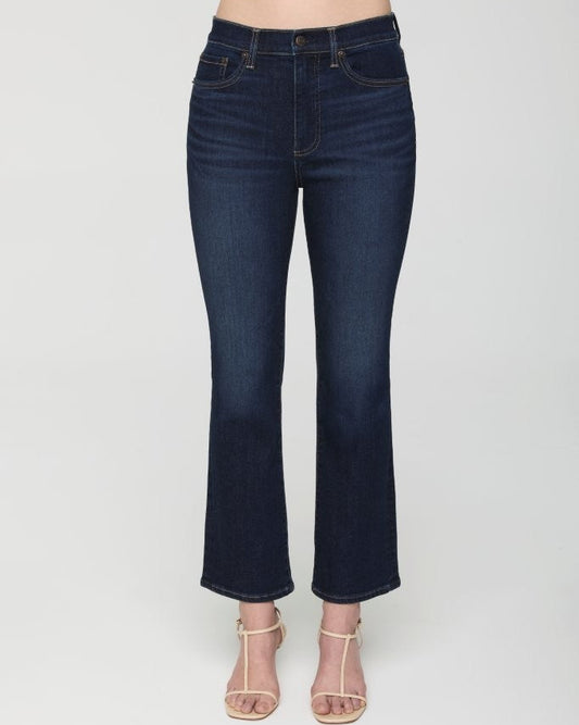 Dark blue jeans worn by a person on a white background