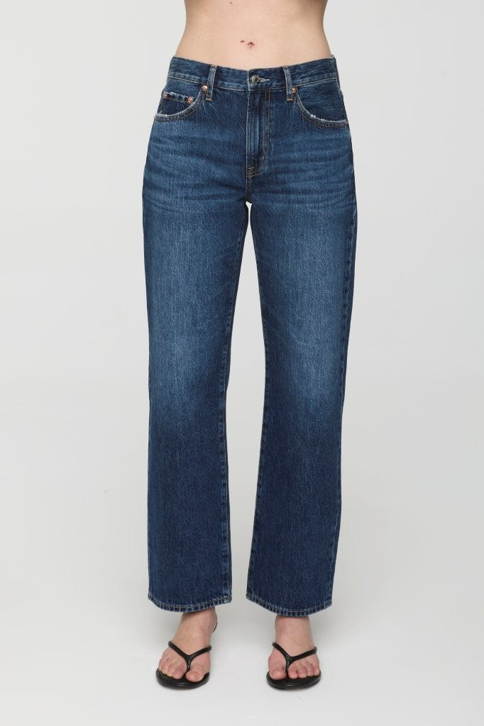 Blue jeans worn by a person on a white background