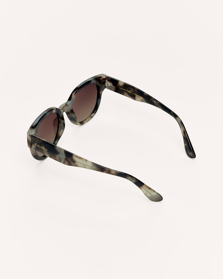 Sunglasses with tortoiseshell frame and brown lenses on a white background
