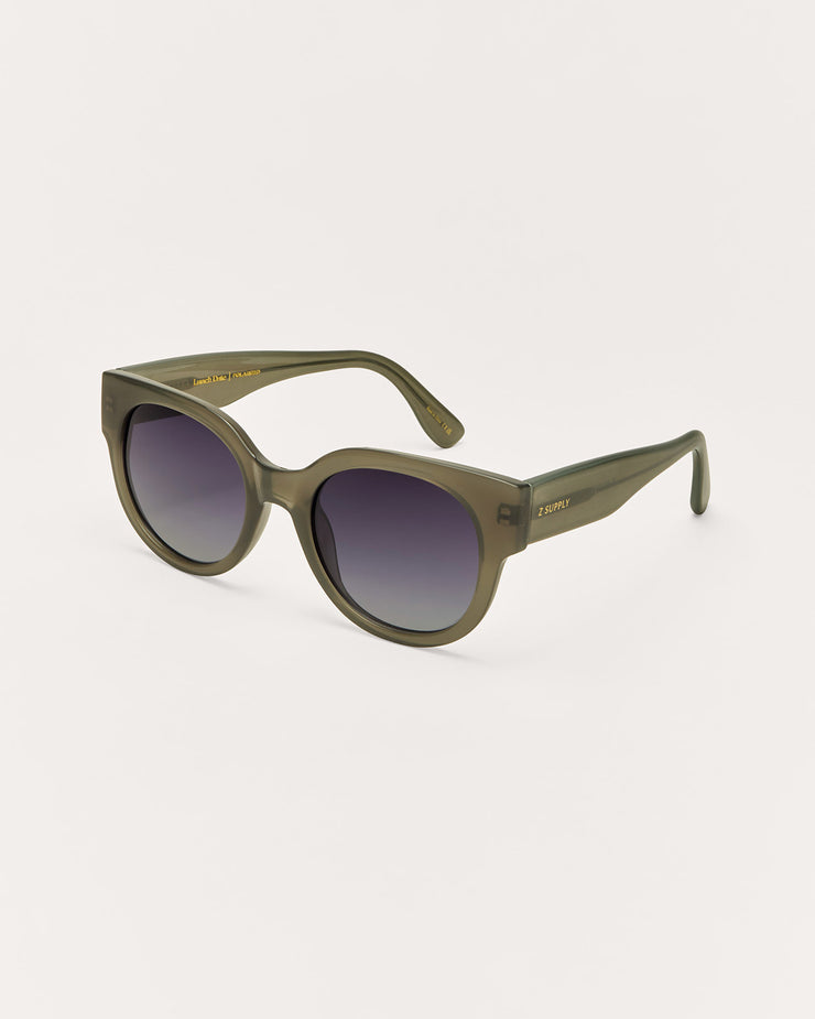 Green sunglasses with a gradient lens on a white background