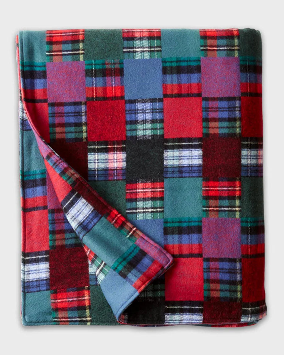 Vermont Flannel plaid blanket with red, blue, and green colors on a white background
