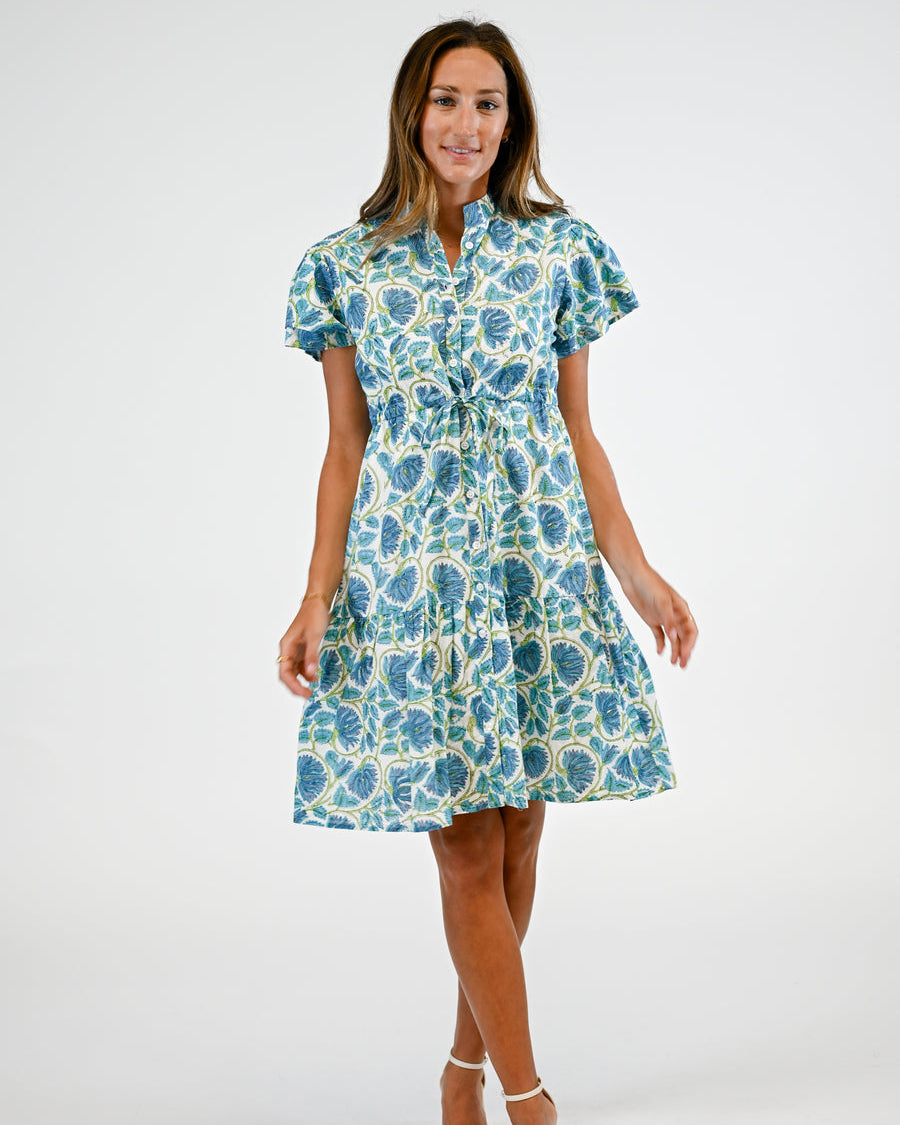 Woman wearing a blue floral dress on a white background