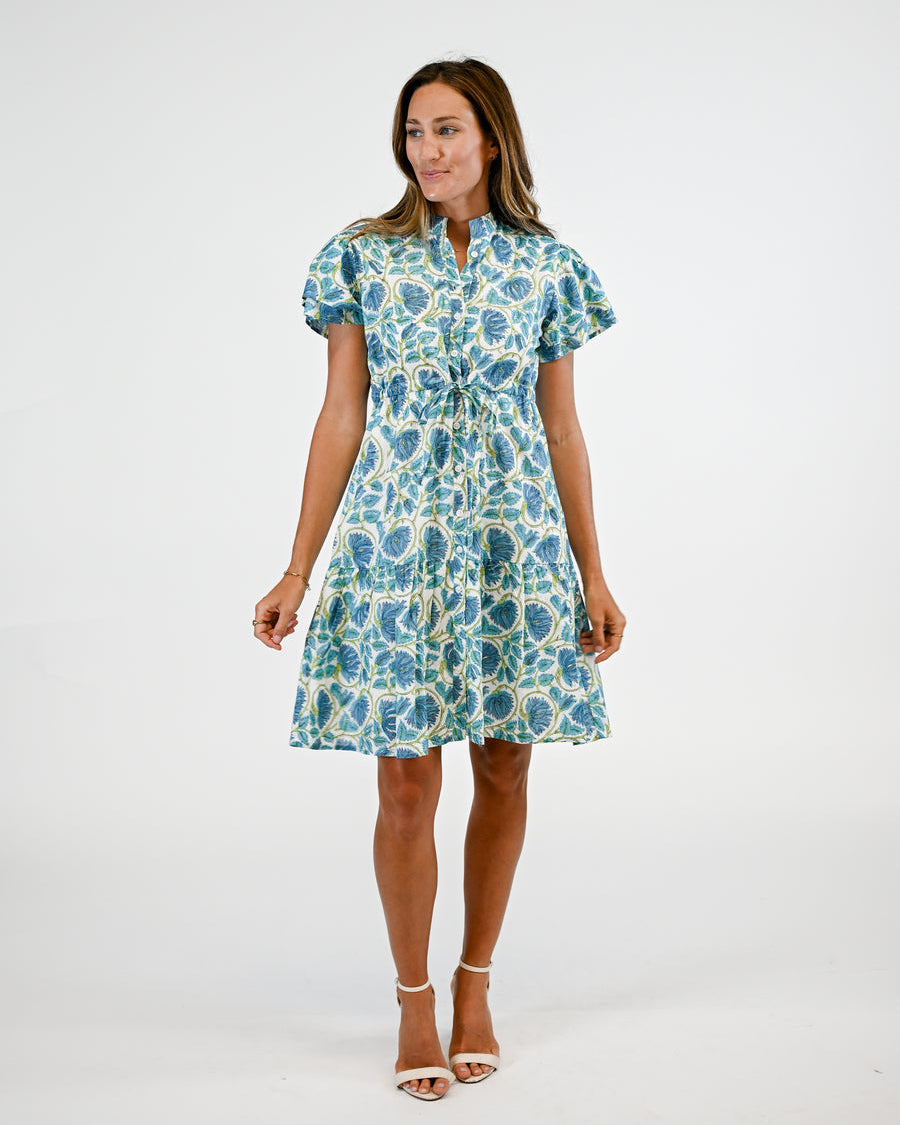 Woman wearing a blue floral dress on a white background