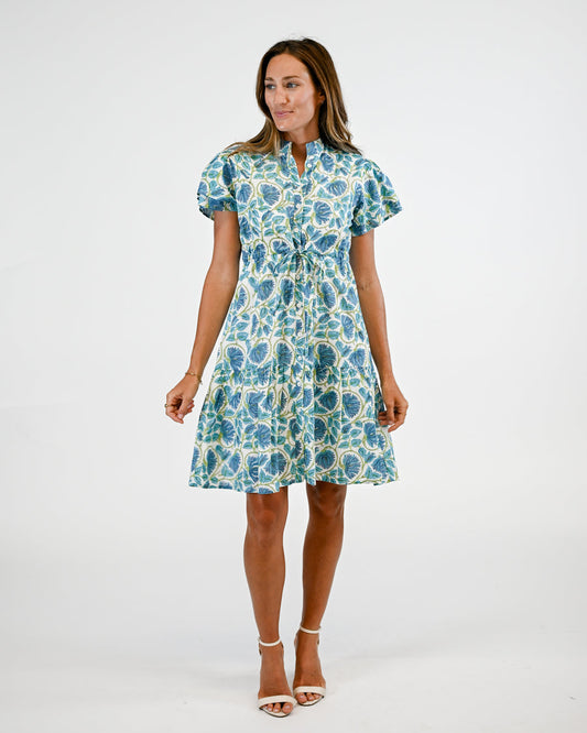 Woman wearing a blue floral dress on a white background
