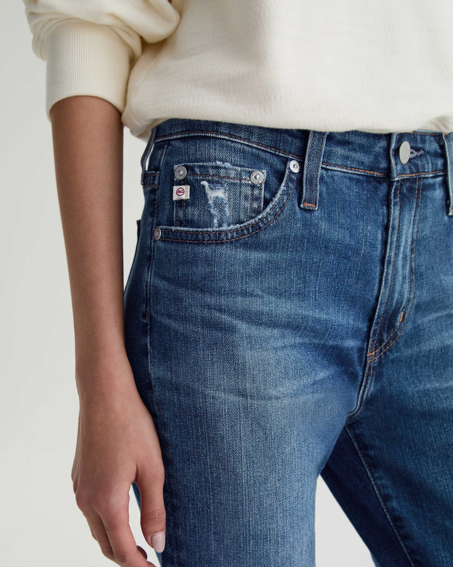 Close-up of blue jeans with a neutral background