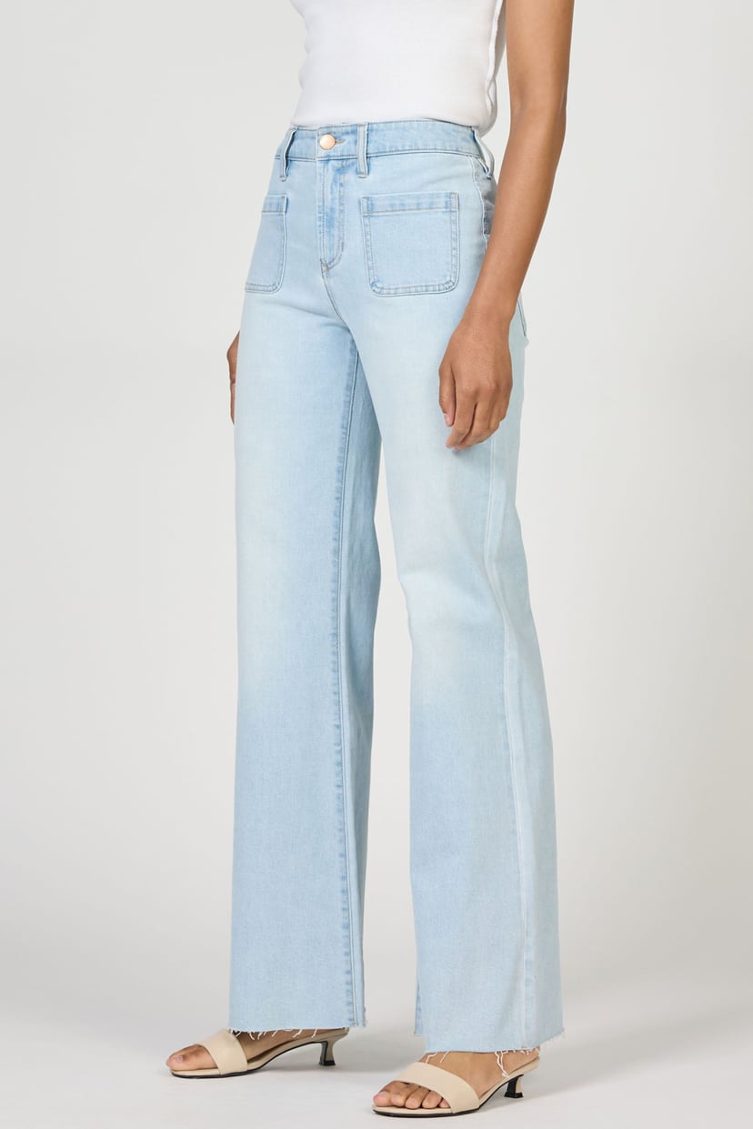 Light blue jeans worn by a person on a white background