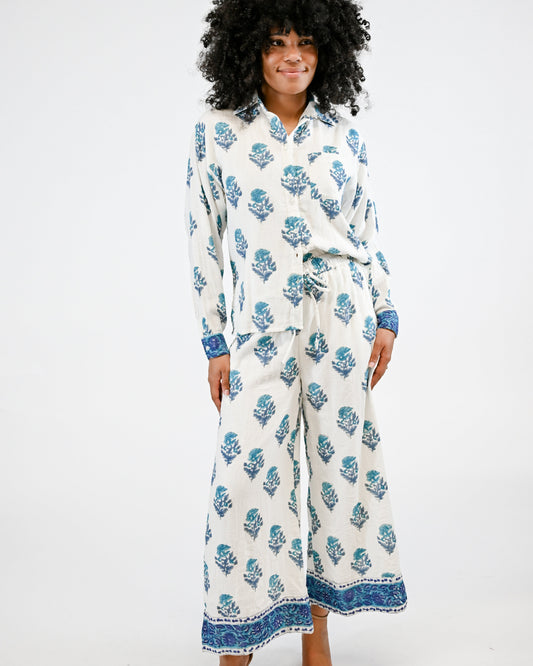 Woman wearing a white floral patterned outfit on a white background