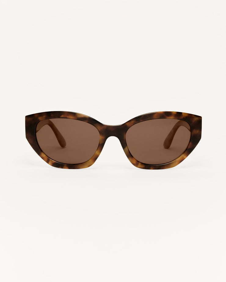 Sunglasses with tortoiseshell frame and brown lenses on a white background