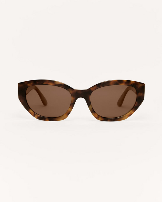 Sunglasses with tortoiseshell frame and brown lenses on a white background