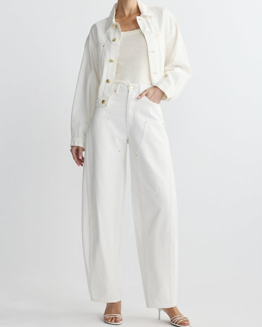 Person wearing a long white coat over a white shirt and pants on a plain background
