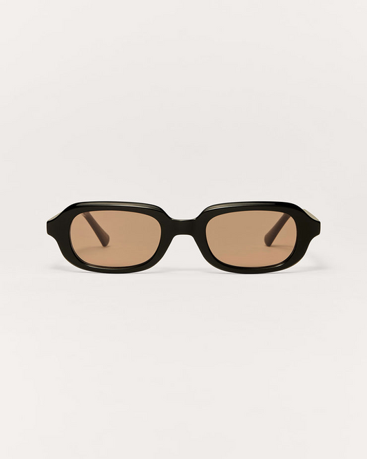 Black sunglasses with brown lenses on a white background