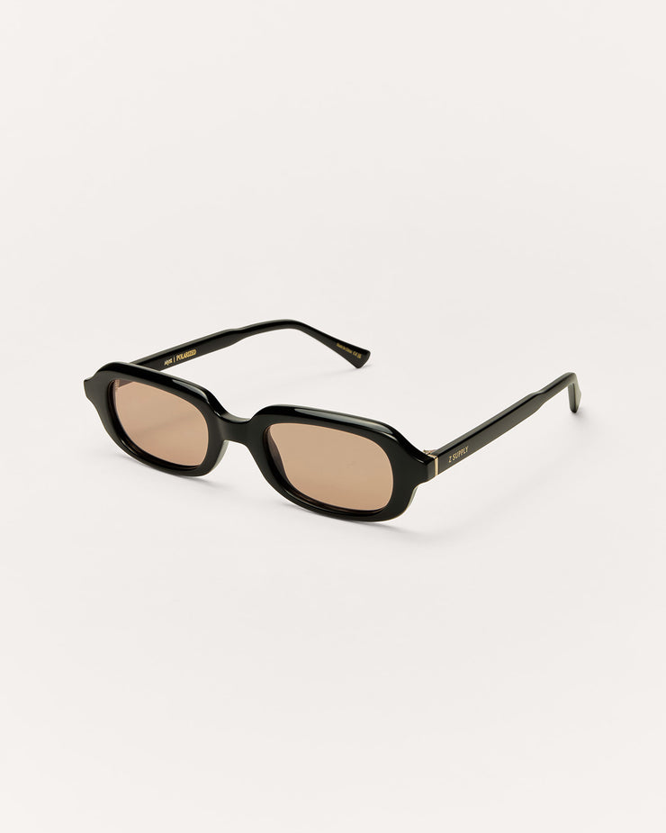 Black sunglasses with beige lenses on a white background