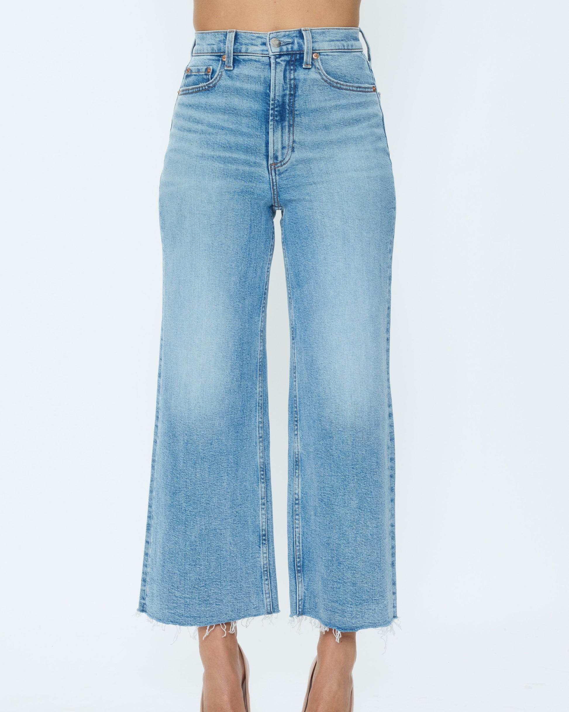 Light blue jeans worn by a person on a white background